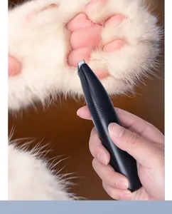 Close-up view of a black electric pet hair trimmer grooming a cat's paw hair detail