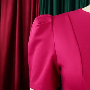 Close-up of elegant fuchsia puff sleeve detail on a structured short-sleeved dress