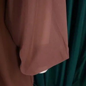 Macro detail of brown chiffon fabric texture showing the soft grain of this summer dress