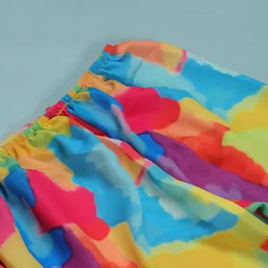 Detailed close-up of vibrant tie-dye pattern and elastic waistband on slim fit dress