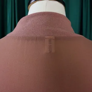 Back neck detail of red-brown chiffon dress featuring ribbed collar texture
