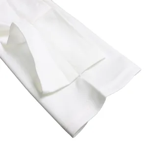 Close-up of white dress sleeve cuff showing detailed stitching and fabric texture.