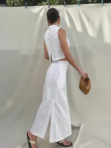 Elegant minimalist white linen two-piece set featuring sleeveless top and long maxi skirt