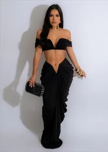 Elegant black two-piece set with strapless V-neck crop top and ruched floor-length skirt