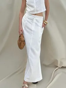 Elegant two-piece white linen set featuring a sleeveless top and a maxi skirt on model