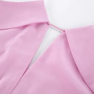 Close-up detail view of a pink linen tank top showing neck strap and fabric texture
