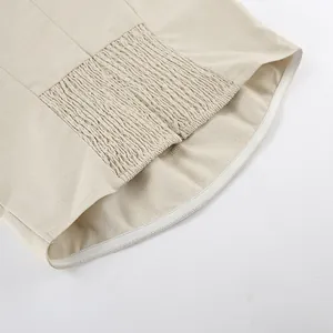 Detailaufnahme eines khakifarbenen trägerlosen Kleides aus Baumwollleinen mit Gummizug.