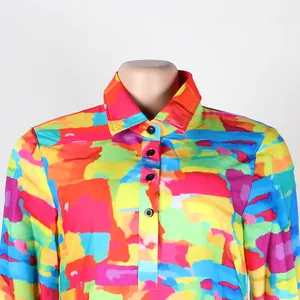 Close-up detail of a colorful abstract print dress featuring a lapel collar and buttons.