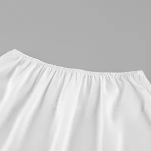 Detailed macro view showing the elastic waistband stitching on elegant white satin