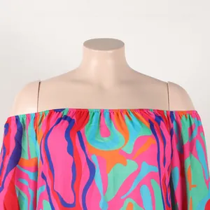 A detail view of a colorful off-the-shoulder printed dress with elastic neckline