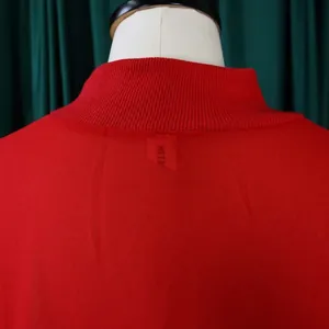 Close-up of red chiffon dress neckline with ribbed collar detail and small label
