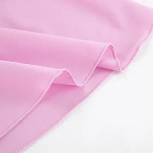 Close-up detail of pink linen fabric texture and stitching for women's summer camisole top.