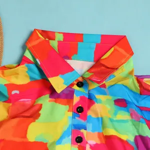 Close-up of the lapel and black button details on a colorful abstract print dress