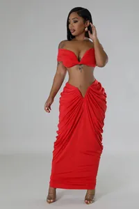 Full view of red two-piece set with off-shoulder top and ruched floor-length skirt