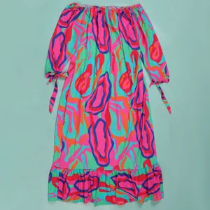 Full view of vibrant abstract print maxi dress with tie-cuff sleeves and ruffled hem.