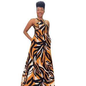 Full view of a sleeveless halter maxi dress featuring bold ethnic yellow and black patterns
