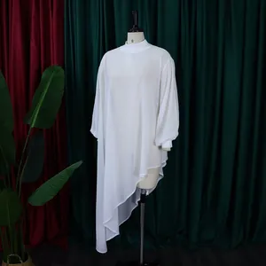 Close-up of white asymmetrical chiffon dress with irregular hem and lantern sleeves