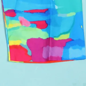 Close-up view of vibrant abstract watercolor print fabric on a slim fit colorful dress
