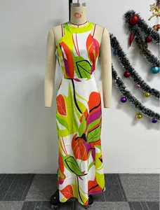 Detail of a slim-fit sleeveless maxi dress featuring a vibrant tropical leaf print