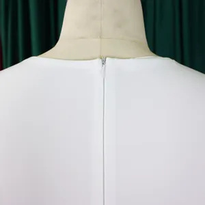 Close-up detail showing the hidden back zipper and neckline of a white elegant dress