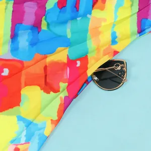 Detailed view of vibrant abstract brushstroke print on a colorful slim-fit cocktail dress