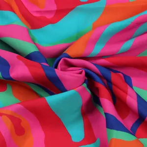 Close-up of vibrant abstract wave print fabric showing smooth texture and drape