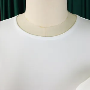 Close-up detail showing the round neckline and fabric texture of a white dress
