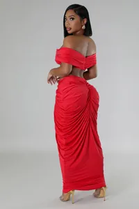 Detailed side view of a red two-piece set featuring off-shoulder top and ruched maxi skirt