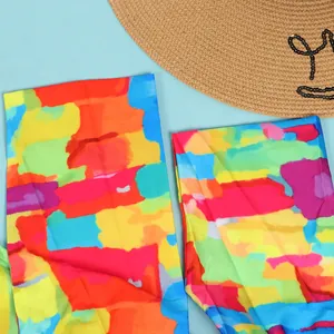 Macro detail of vibrant multi-color abstract print fabric for a slim fit dress.