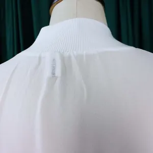 Detailed back view of white summer chiffon dress featuring a ribbed high neck design