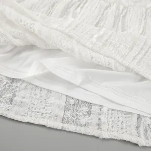 Detailed view of the elegant white lace fabric and inner lining of a bohemian maxi skirt