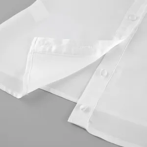 Close-up detail of a elegant white satin shirt showing the buttons and fine hem stitching
