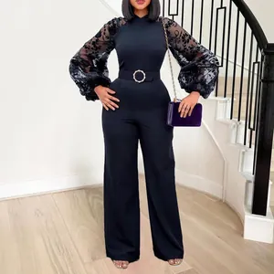 Detailed view of black wide-leg jumpsuit featuring mesh lantern sleeves and matching belt