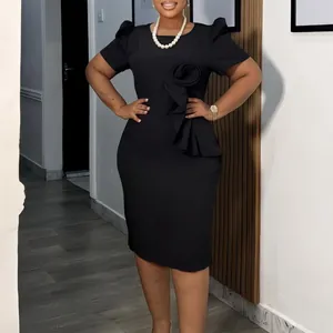 Detailed view of elegant black bodycon dress with unique ruffled floral ornament on waist