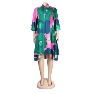 Detail of vibrant floral shirt dress with 3/4 sleeves and high-low hemline on mannequin.