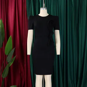 Close-up detail of an elegant black bodycon dress featuring a ruffle flower design on chest