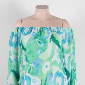 Detailed view of off-the-shoulder neckline on green and blue floral print dress