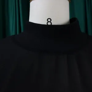 Close-up detail showing the ribbed mock neck texture on this black chiffon dress.