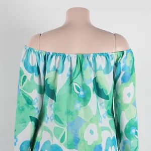 Detailed view of off-the-shoulder floral print dress with green and blue patterns