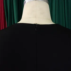 Close-up detail of the back hidden zipper on a black elegant bodycon dress for women.