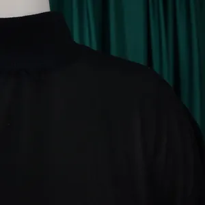 Close-up detail of the elegant high collar and shoulder of a black chiffon plus size dress