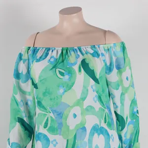 Close-up detail of green floral print off-shoulder dress with elastic neckline