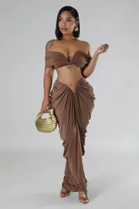 Full view of the sexy brown off-shoulder top and draped pleated maxi skirt set