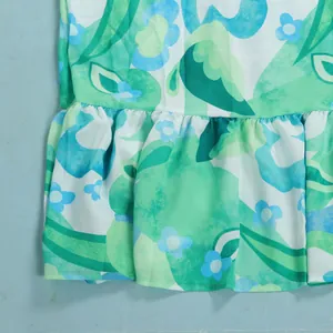 Detailed view of the ruffled hem on this stylish green and blue floral print summer dress
