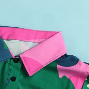 Detailed macro view showing the vibrant multicolored printed collar of a stylish dress.