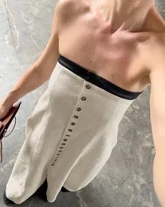 Close-up detail of French style linen strapless dress with elegant button front design