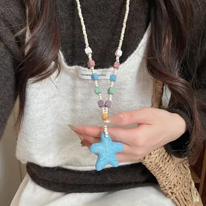 Bohemian long beaded necklace featuring a blue starfish pendant and colorful lava stones