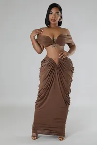 Sexy brown two-piece set featuring off-the-shoulder crop top and draped ruched maxi skirt