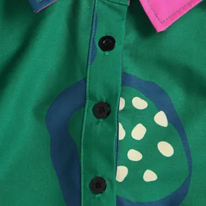 Macro view of a colorful abstract pattern dress featuring black buttons and a stylish lapel