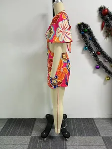 Side view of vibrant floral print cutout romper featuring ruffle sleeves and tie-back detail